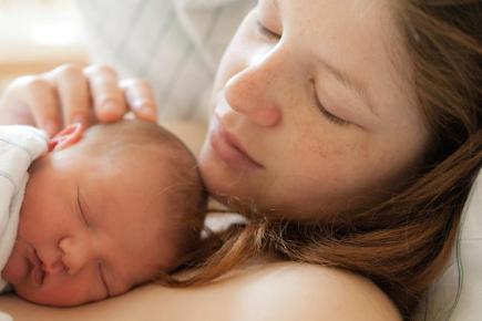 a woman cuddling her newborn baby 136380627316210401 130516134428 min