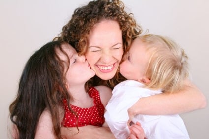 iStock 000002462782XSmall Mom 2 kids kiss min